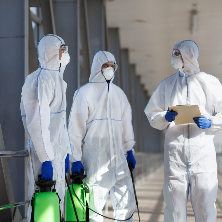 Men in virus protective suits planning to disinfecting city